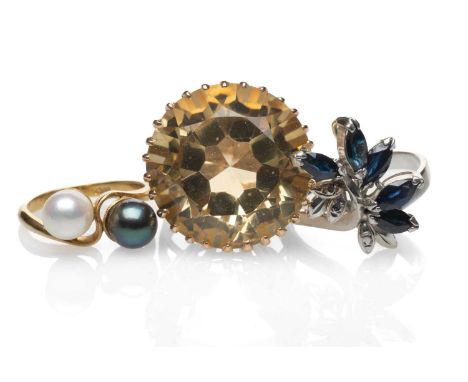 THREE RINGS comprising an 18ct gold white and black pearl twist shank ring, yellow metal citrine dress ring and a white metal