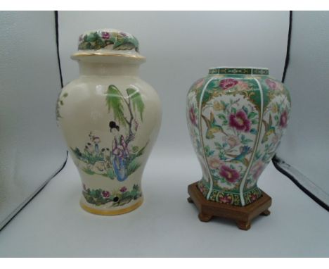 An Oriental lamp base 33cm tall approx. and an Oriental Vase on wooden stand 27cm including stand