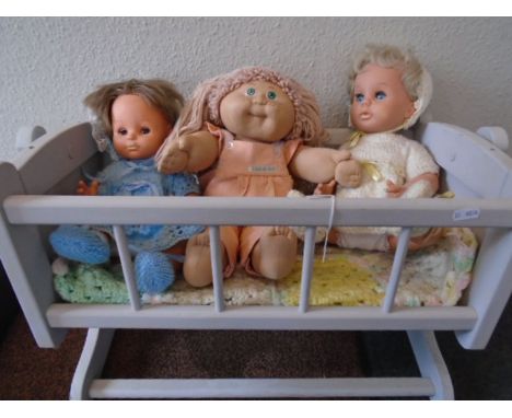 3 vintage dolls - A 'Tiny tears' a 'Fisher price 1982' and a 1985 Cabbage patch kid in a rocking dolls crib. 