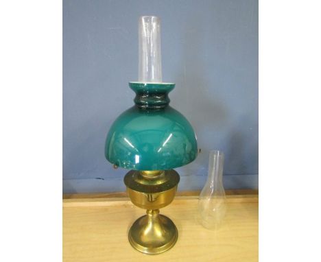 Brass base oil lamp with dark green glass shade and a spare funnel