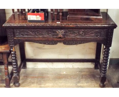 Late Victorian carved pussycat oak hall table fitted one long drawer standing on bobbin turned legs, one damaged 