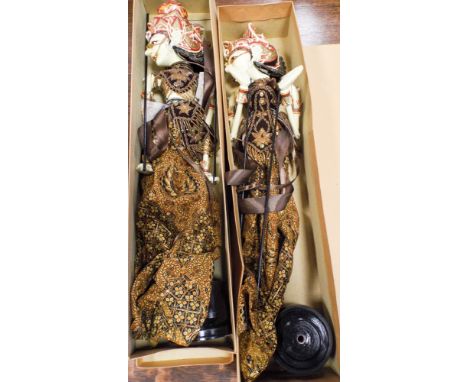 A pair of oriental painted figure dressed stick puppets