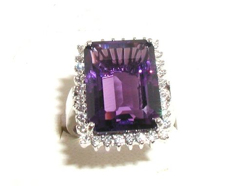 Large and impressive amethyst and diamond cluster ring set with a trap cut amethyst of good colour, surrounding by brilliant 