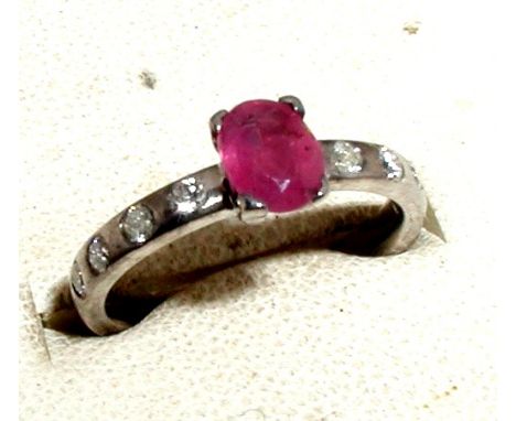 Platinum set ruby and diamond ring, set with a claw set ruby on a platinum band set with diamonds