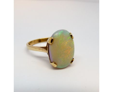 Large single stone opal ring set with an oval opal in a claw setting on a 9ct gold shank