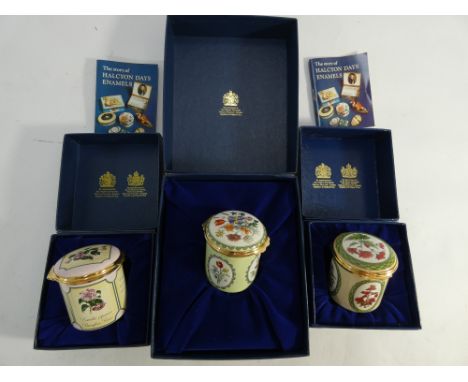 Collection of three Halcyon Day enamel cylindrical boxes decorated with flowers, all in original boxes 