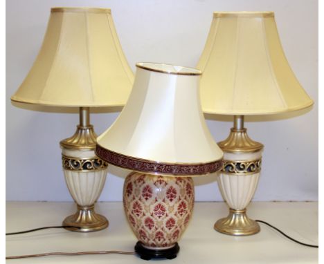 A pair of decorative table lamps with silk shades and a further ceramic table lamp and shade, overall H. 70cm.
