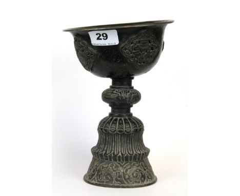 A 19th/ early 20th century large Tibetan hammered copper yak butter candle lamp, H. 22cm.