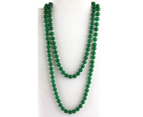 A longuard of polished apple green jade beads, Dia. 10mm, L. 120cm.