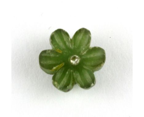An unmounted carved jade flower set with a diamond, approx. 3.36ct.