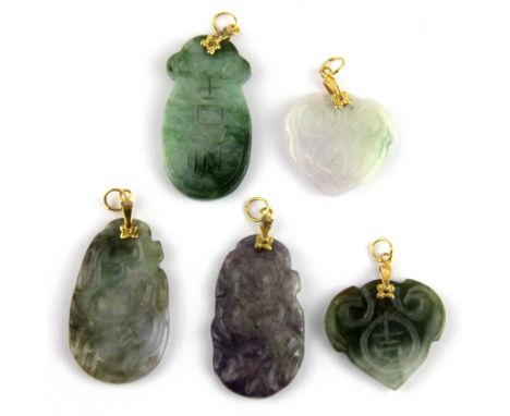 A group of five Chinese carved jade and hardstone pendants, largest H. 4cm.