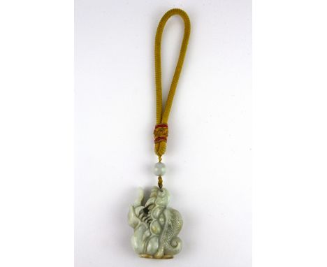 A superb 19th Century Sino-Tibetan carved jade protective amulet with Tibetan yellow silk carrying cord, jade size 7 x 5 x 2c