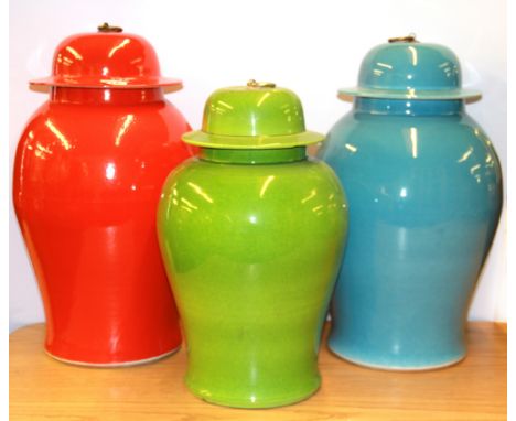 Three large decorative ceramic jars and lids, tallest H. 50cm.