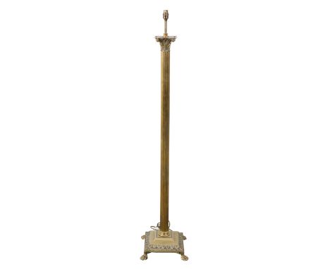 A BRASS COLUMNAR STANDARD LAMP with a Corinthian capital on a reeded stem, to a moulded base with hairy lions paw feet, 127cm