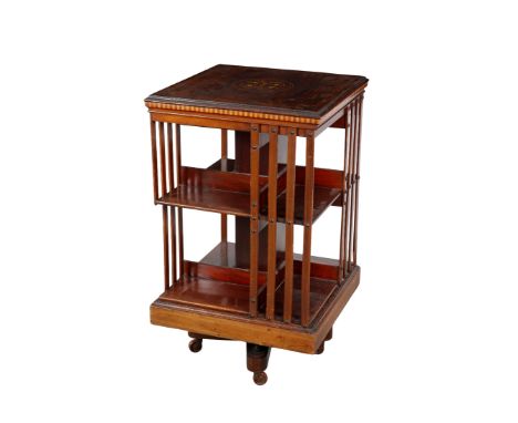 AN EDWARDIAN MAHOGANY AND MARQUETRY REVOLVING BOOKCASE 20th century, the top inlaid with a central medallion of foliate spray