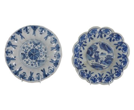 AN ENGLISH DELFT BLUE AND WHITE CHARGER probably London, of lobed form, decorated in the oriental style with a lady seated to