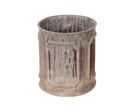 A LEAD CYLINDRICAL PLANTER of 18th Century design with panelled exterior, 38cm high x 33cm diameter