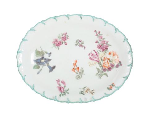 A CHELSEA PORCELAIN DISH Mid-18th century, of oval form, decorated with floral sprays with a green formed border, red anchor 