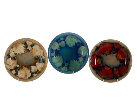 THREE MOORCROFT DESSERT PLATES with varying leafage and berry pattern design, 22cm diameter (3)From the collection of the lat