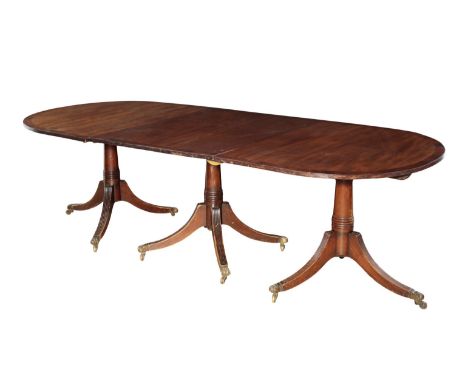 A MAHOGANY THREE PILLAR DINING TABLE of George III design, with two additional leaves, 309cm x 105cm 