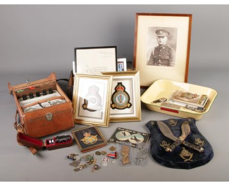 A mixed quantity of collectables including framed RAF patches, shield display with mounted pair of miniature kukri and cap ba