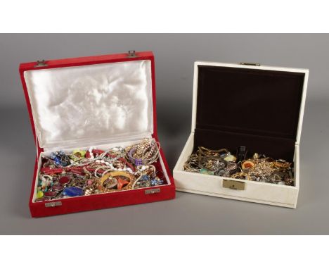 Two jewellery boxes containing costume jewellery. Includes coloured glass set bangle, dress rings, necklaces, brooches, ladie