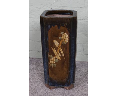 A 1920s vintage Chinese concrete umbrella stand, featuring a glazed ceramic bird scene. Square form with drainage holes to th