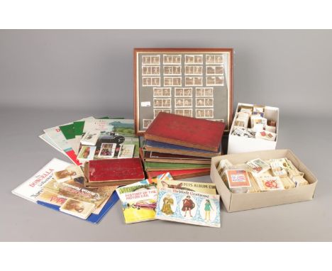 A large collection of assorted cigarette cards, trade cards, silk cigarette cards, albums and a framed 1930s tennis cigarette