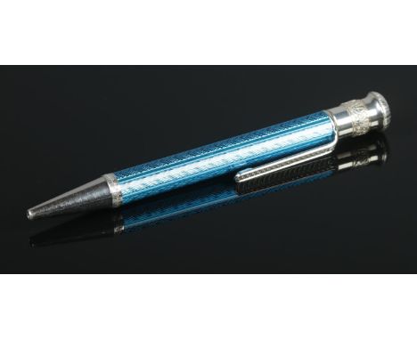 A silver and blue enamel retractable ball point pen with engine turned barrel. Assayed London 2000 by JEP, Jack Edward Perry.