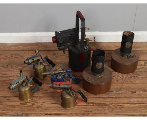 A collection of vintage oil lamps and blowtorches to include industrial example and British Ingelite examples.