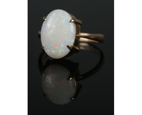 A 9ct gold ring set with large opal cabochon stone. Size M, 2.6g. Opal approximately 1.5cm x 1cm.  Good condition. Slight mov