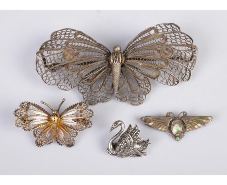 Three silver butterfly brooches, along with a marcasite set swan brooch. Contains a large filigree and small enameled Charles