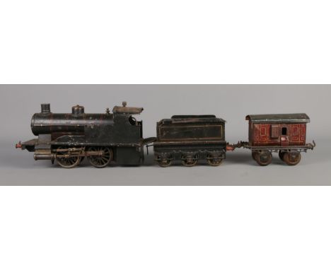 A vintage Gebruder Bing 0-4-0 O Gauge steam engine and tender.  Signs of wear.