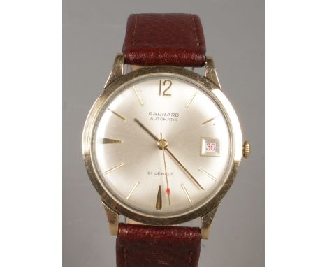 A gents 9ct gold Garrard automatic wristwatch. With centre seconds, baton markers and date display.  Running.