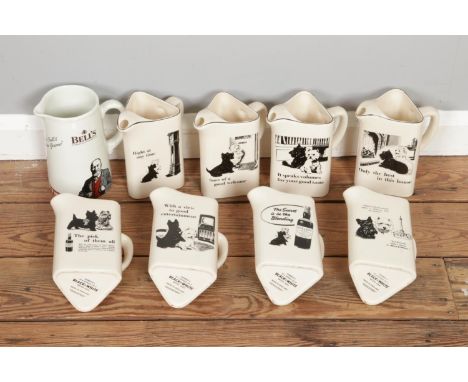 Eight vintage "Black &amp; White Scotch Whisky" advertising jugs with an additional "Bell's" whisky jug.  All in good conditi