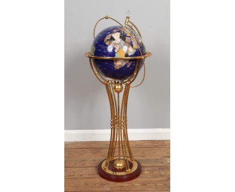 A floor standing gemstone globe raised on a shaped support and wooden base.