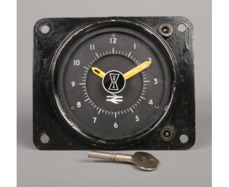 A vintage mechanical railway clock manufactured by Deuta. Bearing British Rail Double Arrow mark to dial. Dial diameter appro
