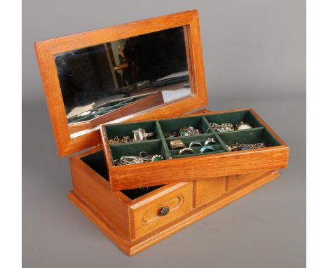 A table top jewellery box with mirrored lid containing a good collection of costume jewellery. To include cameo brooches, dre