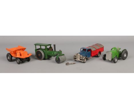 Four Tri-ang Minic clockwork vehicles, to include 'back and forth' steam roller, tractor and dust cart.  Play-worn.