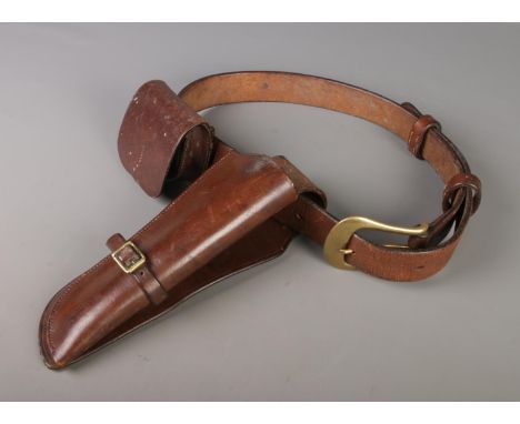 A Colt Walker holster attached to belt with additional pouch utility pouch.