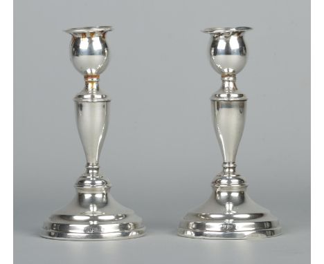 A pair of George V silver candlesticks. Assayed London 1913 by Edward Barnard &amp; Sons Ltd. Height 16.5cm. 495g (weighted b