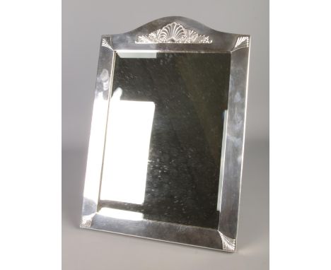 A large silver plate easel dressing table bevel edge mirror bearing shell motif to frame. Approx. dimensions 36cm x 51cm.