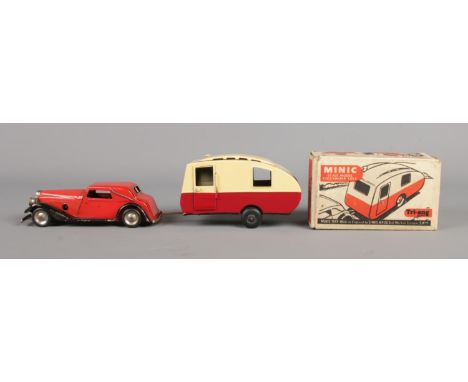 A Tri-ang tin plate Vauxhall cabriolet in red with black sides, together with boxed Tri-ang caravan.  Car in play-worn condit