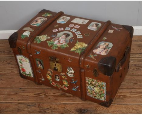 A vintage steamer trunk bearing M.S initials to side and decoupaged using assorted Victorian scraps.