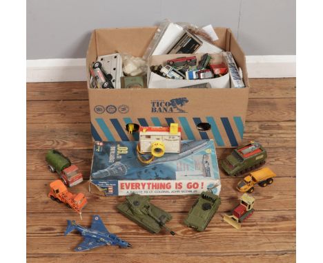 A box containing a large collection vintage toys and games, including tins, board games and die-cast vehicles from Dinky, Cor