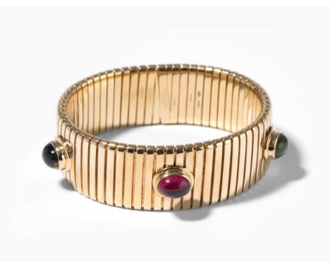 Bulgari Farbedelstein-ArmspangeItalien. Signiert. Modell "Tubogas". 750 Gelbgold. Mit Peridot-, Rosa-Turmalin- und Amethyst-C