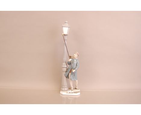A modern Lladro figure of the Lamp Lighter, 48cm, numbered 5205, with long metal lighting pole (2)