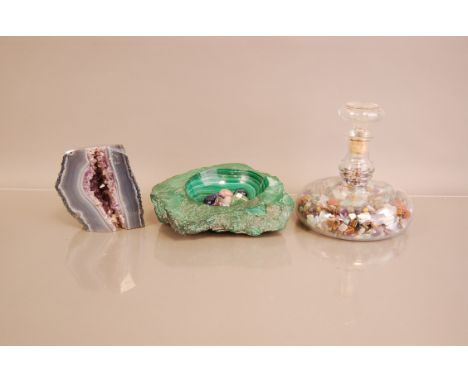 A vintage carved malechite ashtray, together with a section of an amethyst geoded and a glass decanter full of stone specimen