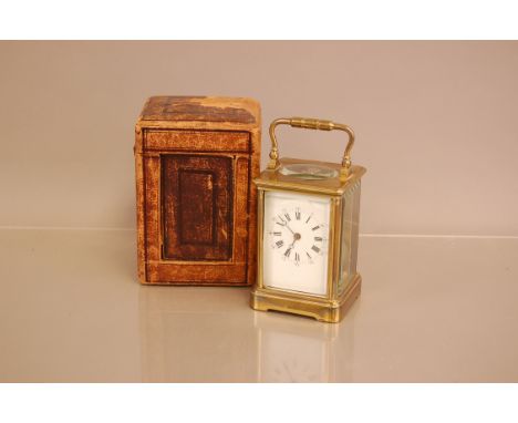 A vintage brass carriage timepiece, with travel case