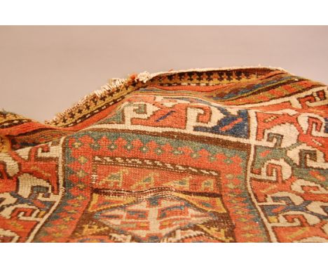 A vintage Middle Eastern woollen carpet, some wear
